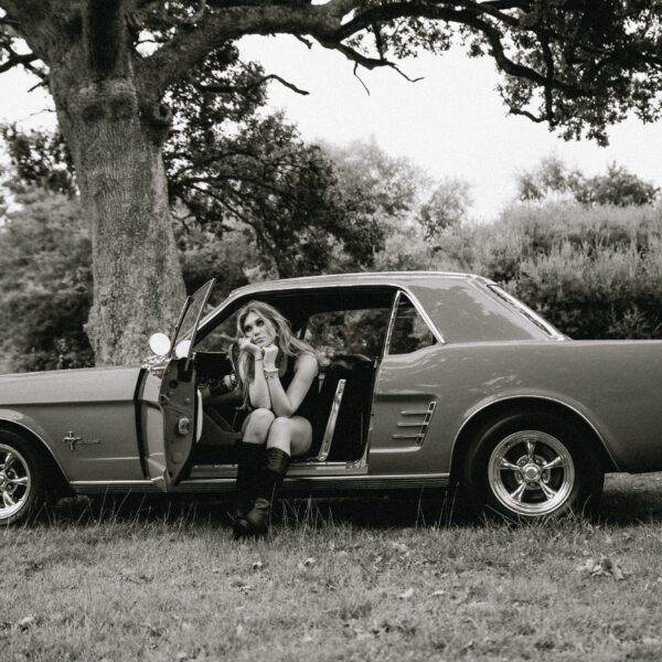 Ria Hanley sitting in a classic car