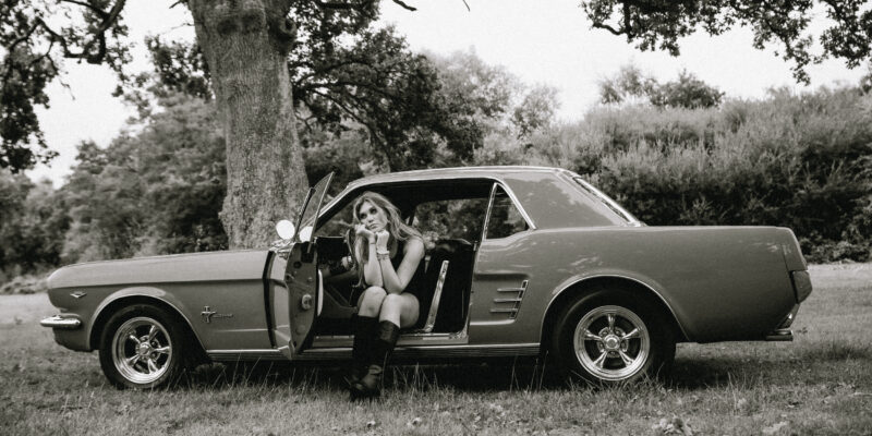 Ria Hanley sitting in a classic car