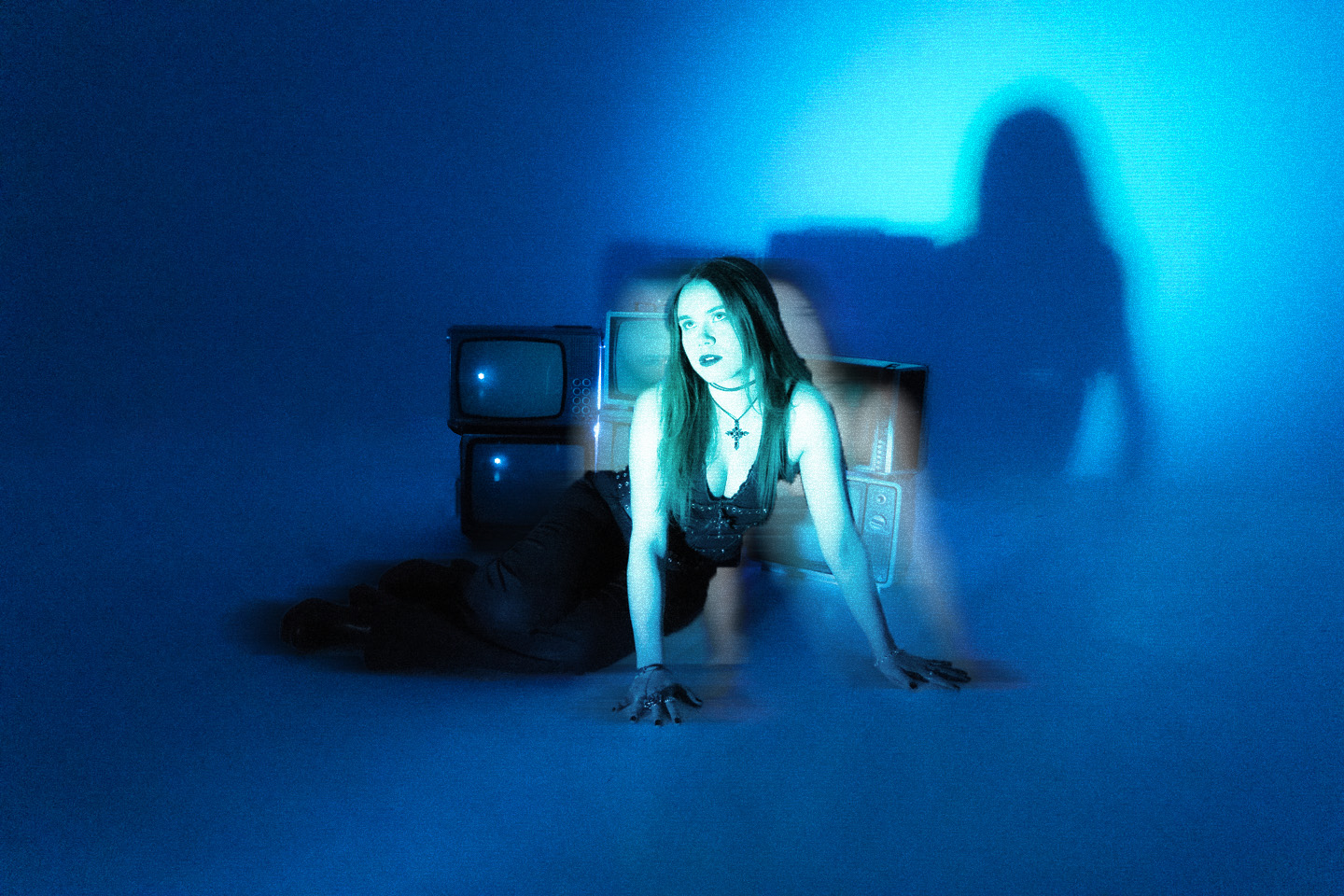 Emily Volt in front of a broken television