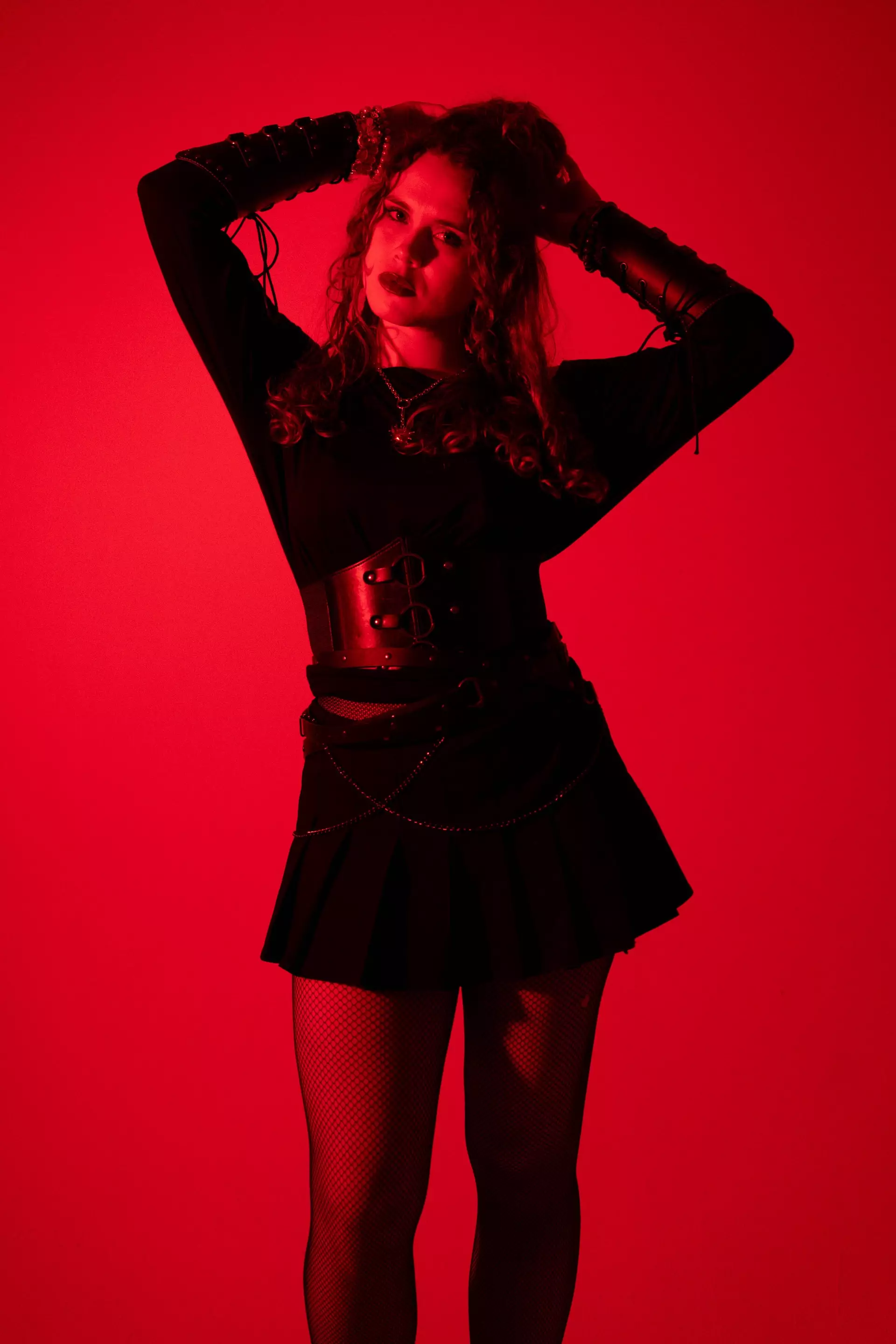 Emily Volt in red-lit press photo